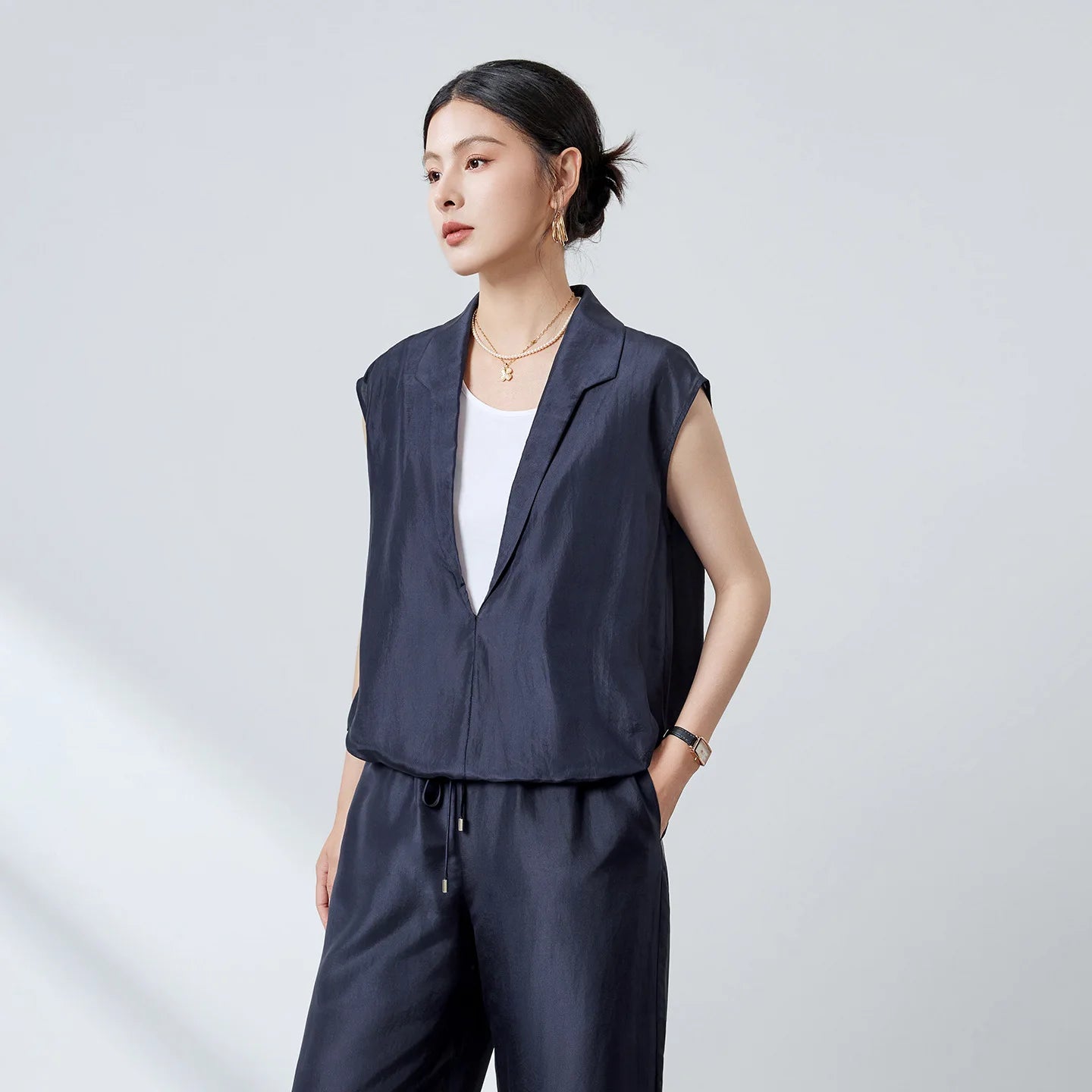 Women's Habotai Mulberry silk blouse in Blueprint. Featuring an elongated stepped shawl collar and a white tank top, joined at the elasticated hem. — From Borcelleclothes.