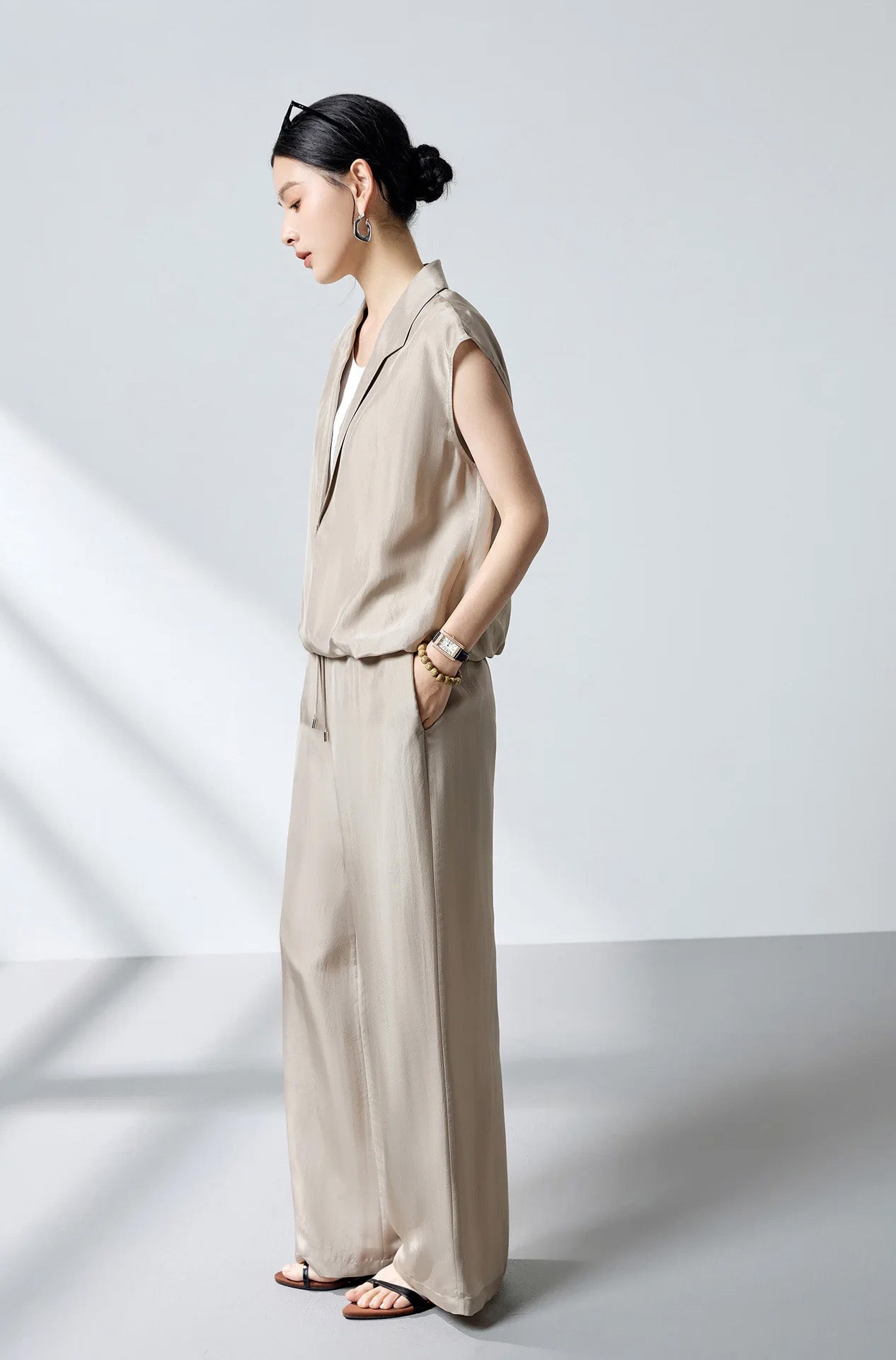 Side profile of model showcasing the fluid blouson silhouette and draped armhole of Morning Draft silk top — From Borcelleclothes.