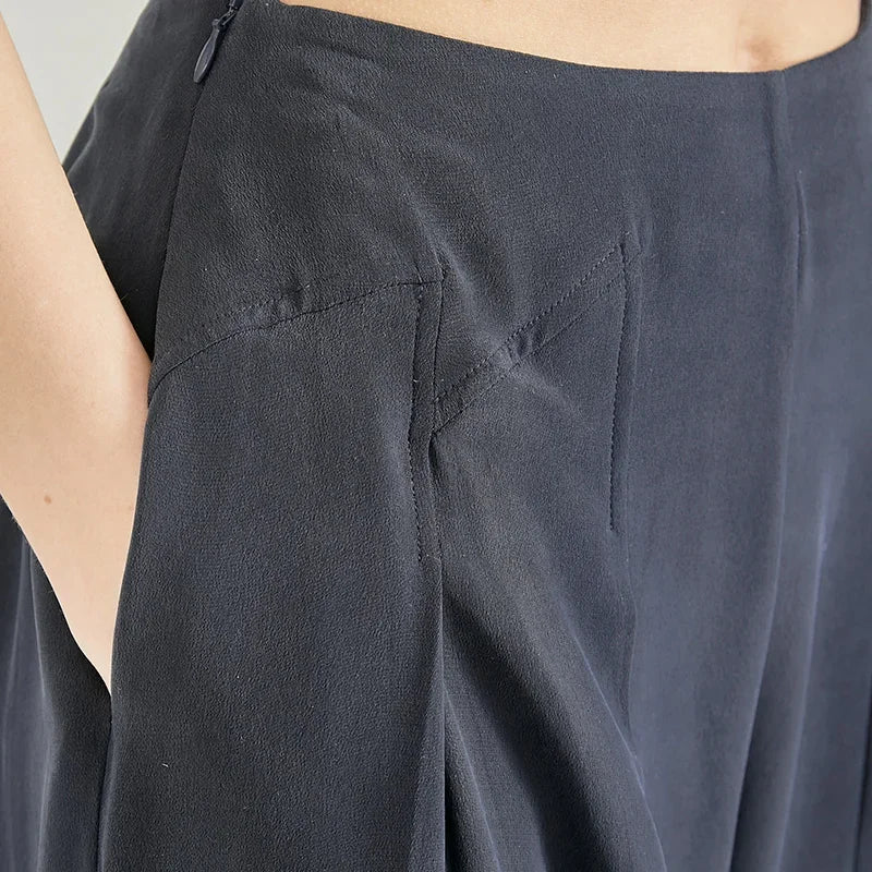 Close-up of hand in pocket detailing on Dark Eyes Mulberry silk trousers with stepped side yokes — From Borcelleclothes.