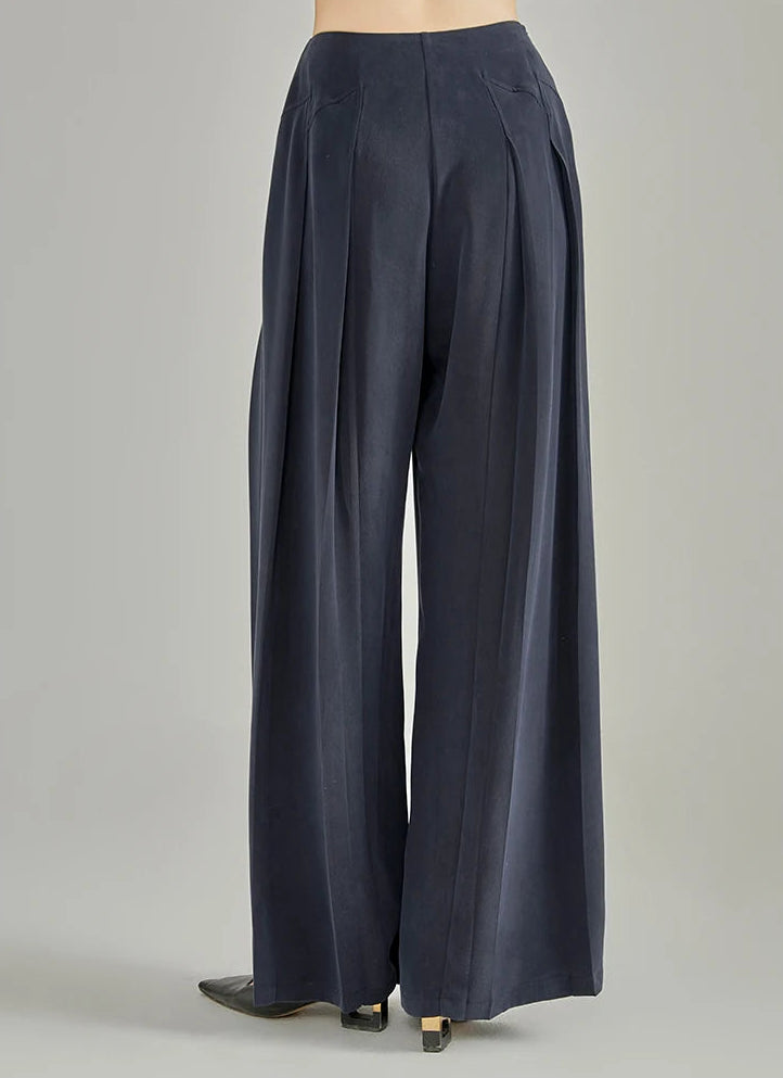 Back view of wide-leg Dark Eyes Mulberry silk trousers highlighting rear integrated pleats — From Borcelleclothes.