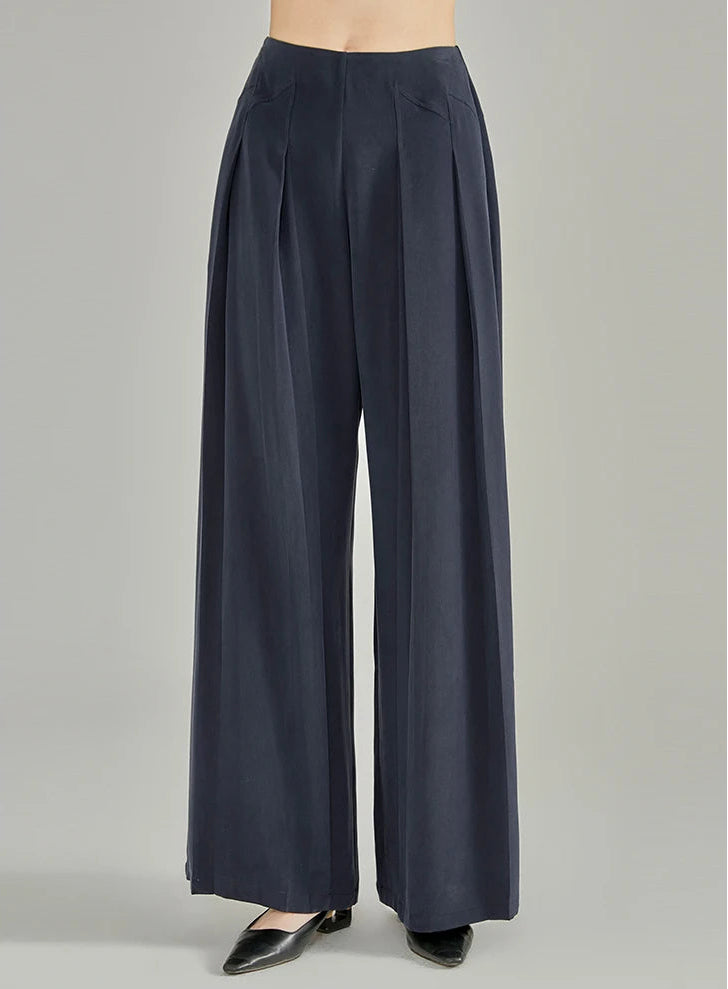 Full front view of women's floor-length Dark Eyes sandwashed silk trousers with stepped side yokes — From Borcelleclothes.