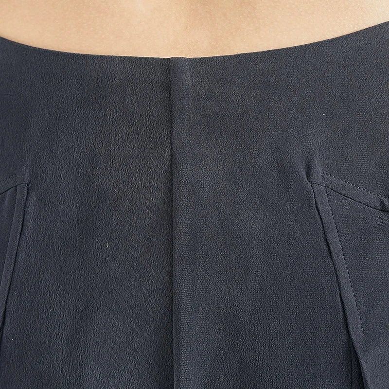 Close-up of the back waist section showcasing rear integrated pleats on Dark Eyes Mulberry silk trousers — From Borcelleclothes.