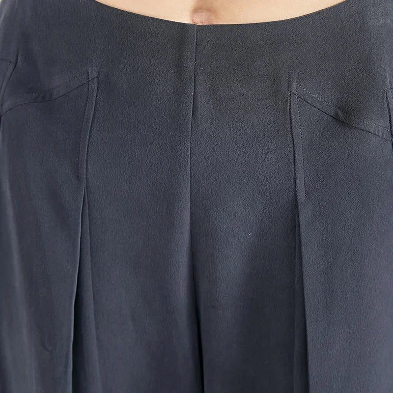 Detailed front view of the waist section and integrated pleats below stepped yokes in Dark Eyes silk crepe — From Borcelleclothes.