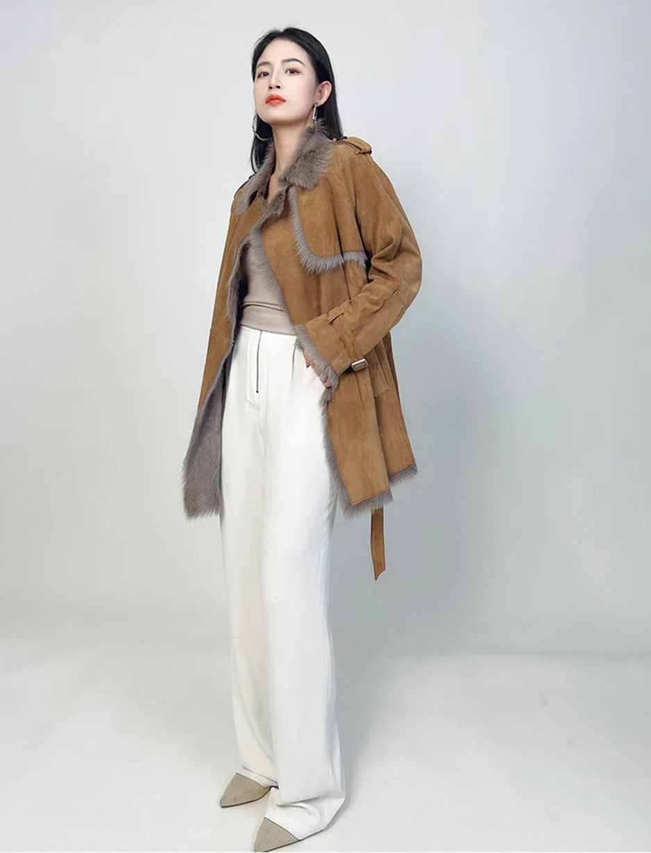 Model with hand in pants pocket, wearing Gold Ransom coat — From Borcelleclothes.