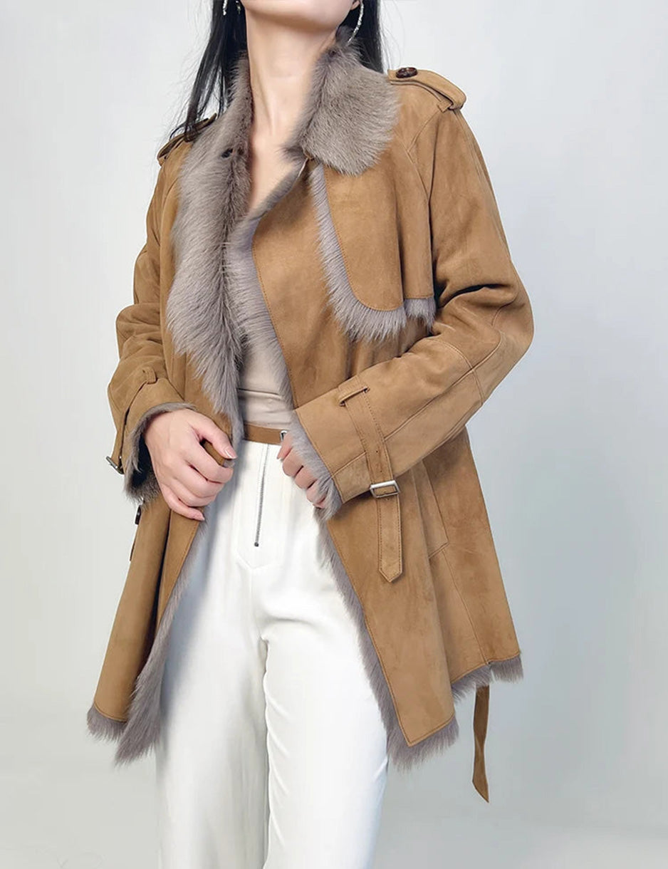 Model holding both front edges of the unfastened goatskin coat — From Borcelleclothes.