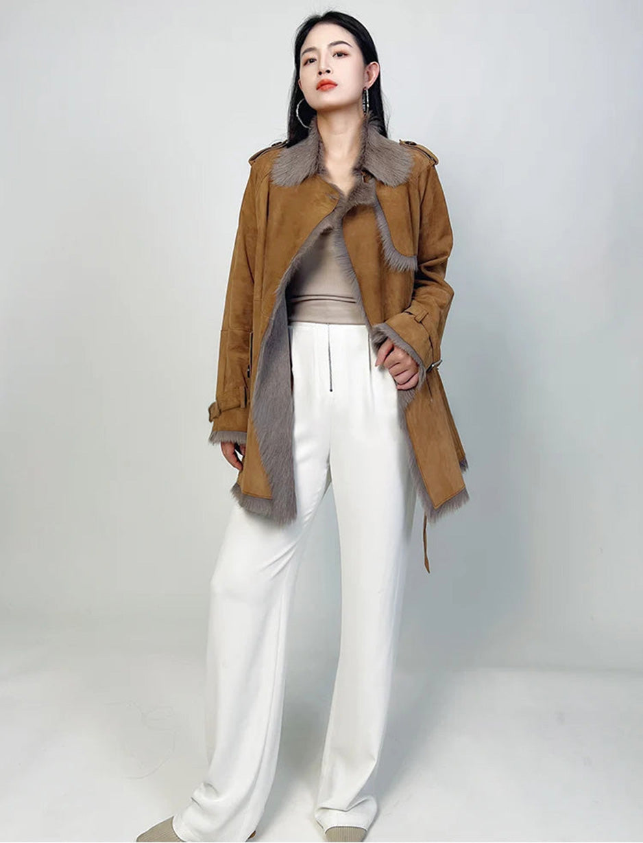 Model touching the front edge of the open goatskin coat — From Borcelleclothes.