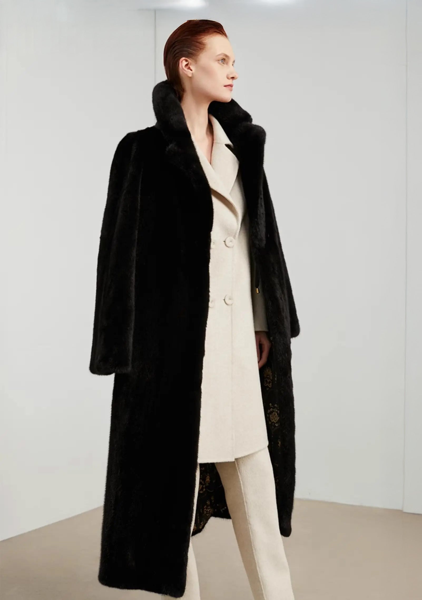 Model in straight-cut mink coat in rich black, turned slightly to the side — From Borcelleclothes.