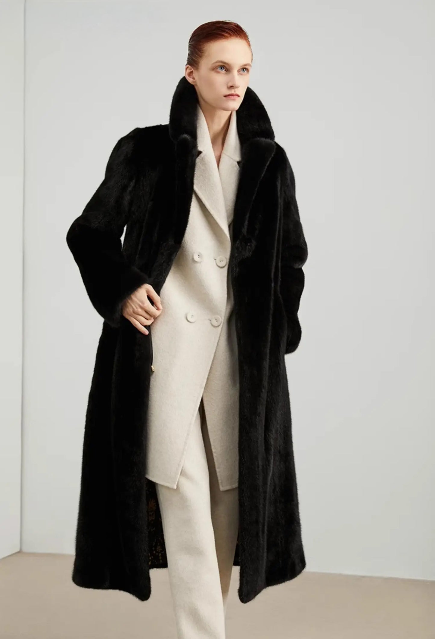 Women's full-length straight-cut mink fur coat in Rich Black with high collar, notch lapels, and invisible closure — worn with confidence and restraint. From Borcelleclothes.