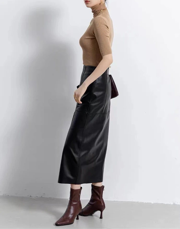 Side view of a model showcasing the straight silhouette of a sheepskin midi skirt in Dark Horse — From Borcelleclothes.