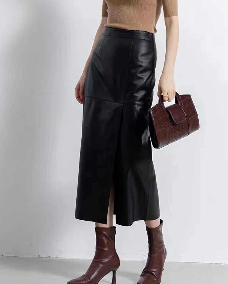 Model turned slightly to the side in a straight sheepskin midi skirt with an asymmetric slit in Dark Horse — From Borcelleclothes.