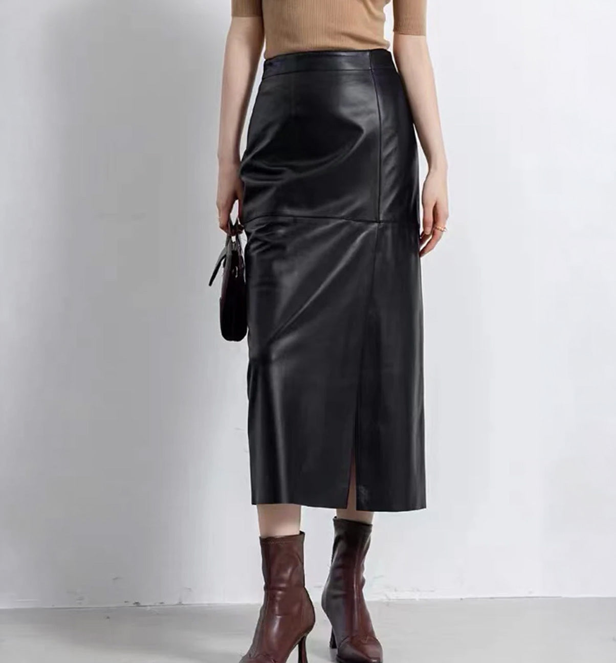 Women's straight silhouette, genuine sheepskin midi skirt in Dark Horse, featuring an asymmetric front slit and invisible back zipper.  — From Borcelleclothes.