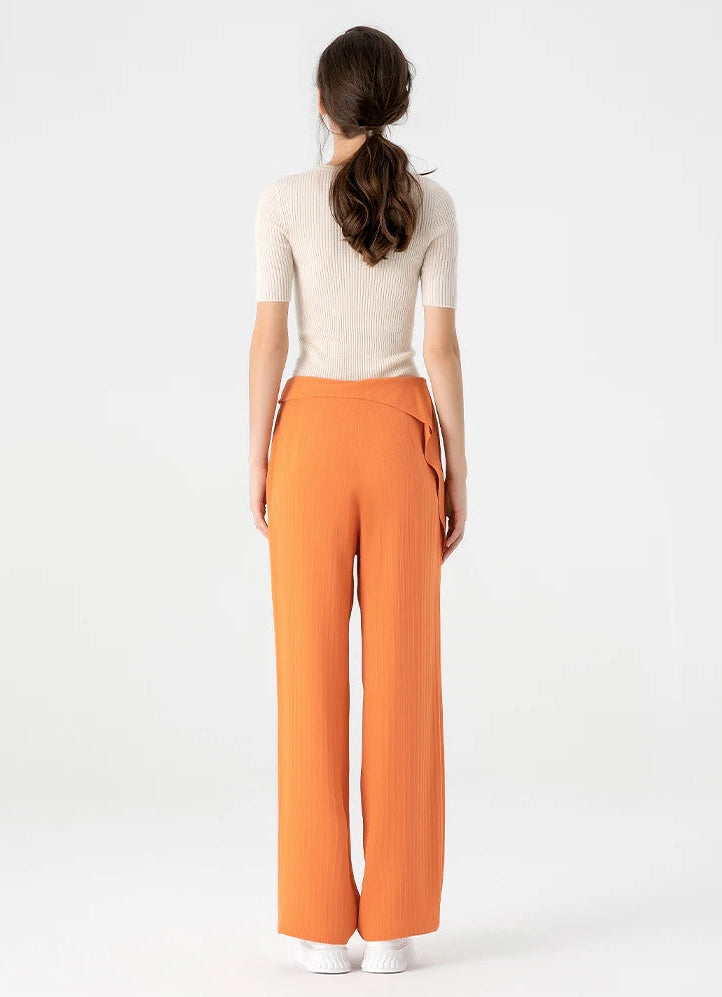Full-height back view of a woman wearing floor-length Fragrant Cloud Mulberry silk jacquard trousers with back waist darts — From Borcelleclothes.