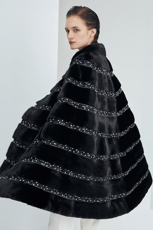 Women's striped mink fur cape in black with gemstone-accented satin bands and beaded brooch fastening. — From Borcelleclothes.