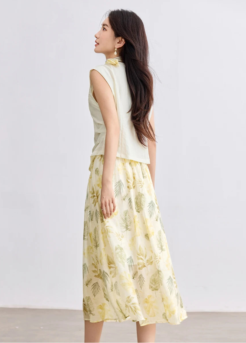 Back view of a woman wearing the Sydney Breeze set, showing the tailored vertical darts of the vest and clean skirt lines — From Borcelleclothes.