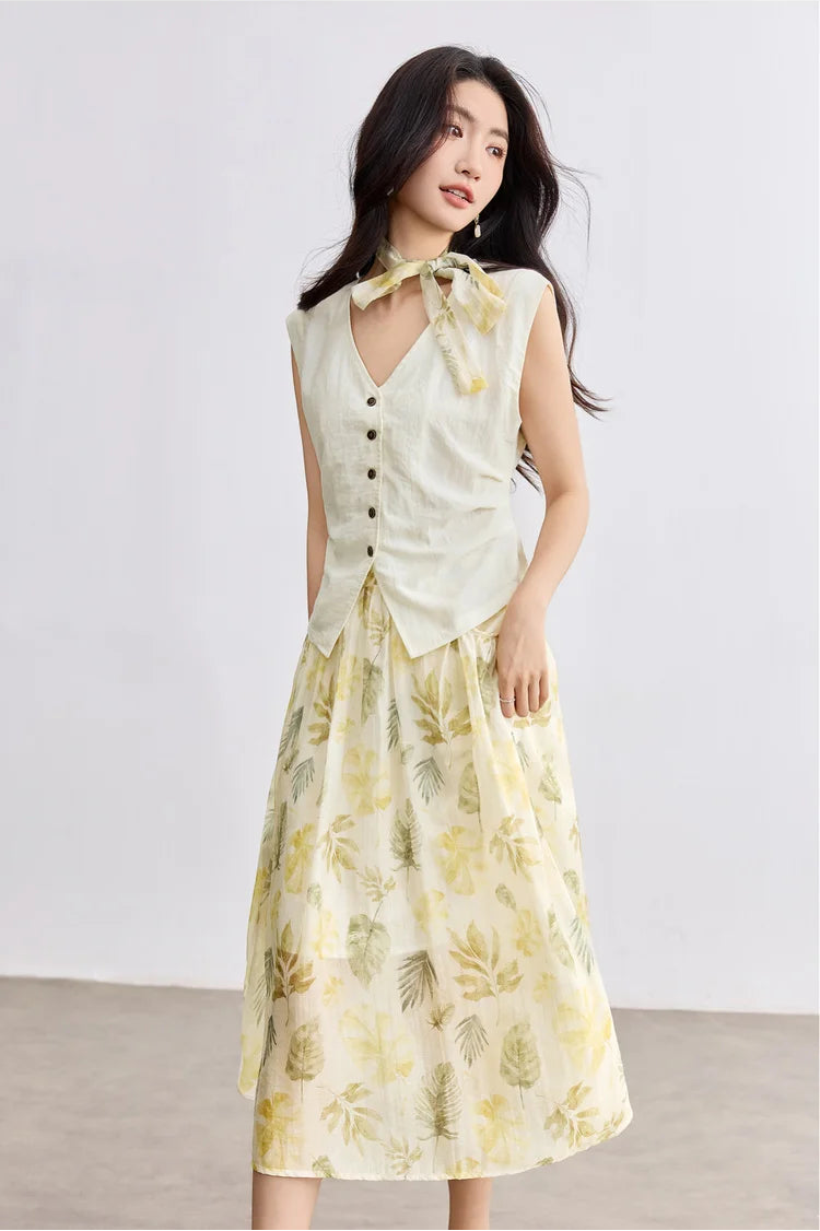 A woman in motion wearing the Sydney Breeze set, capturing the airy flow of the pleated skirt and structured vest — From Borcelleclothes.