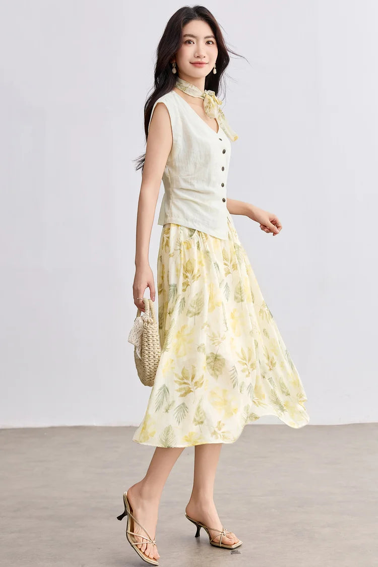 Side view of a woman walking in the Sydney Breeze set, highlighting the movement of the botanical print skirt — From Borcelleclothes.