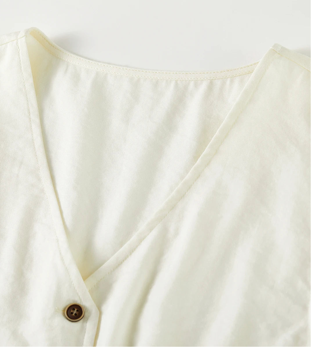 Detail shot of the V-neckline and collarless design of the Sydney Breeze viscose vest — From Borcelleclothes.