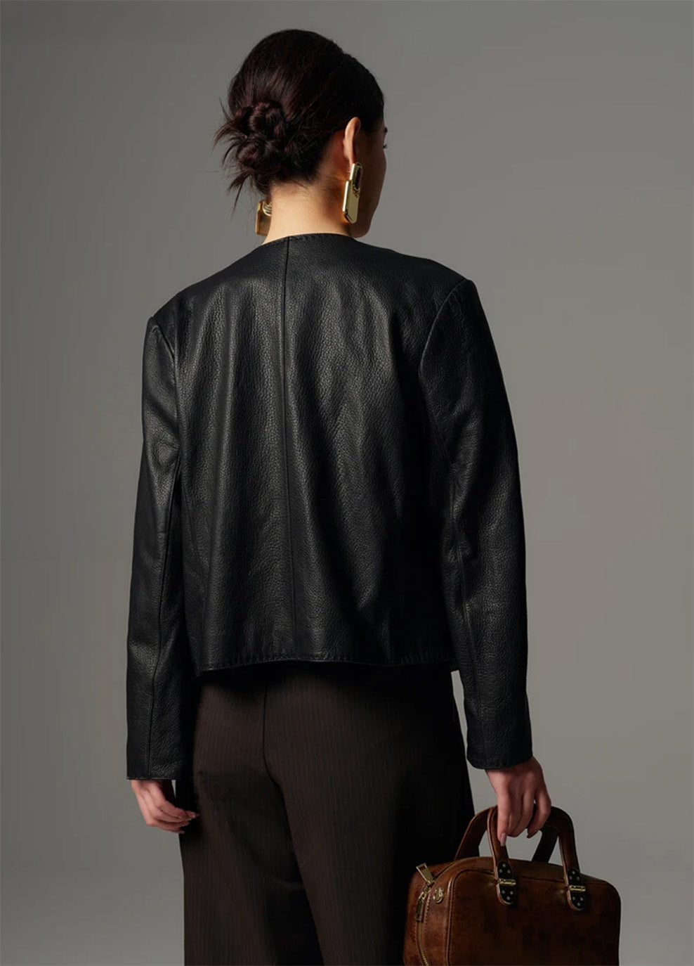 Back view highlighting the contoured princess seams of the cropped goatskin jacket — From Borcelleclothes.