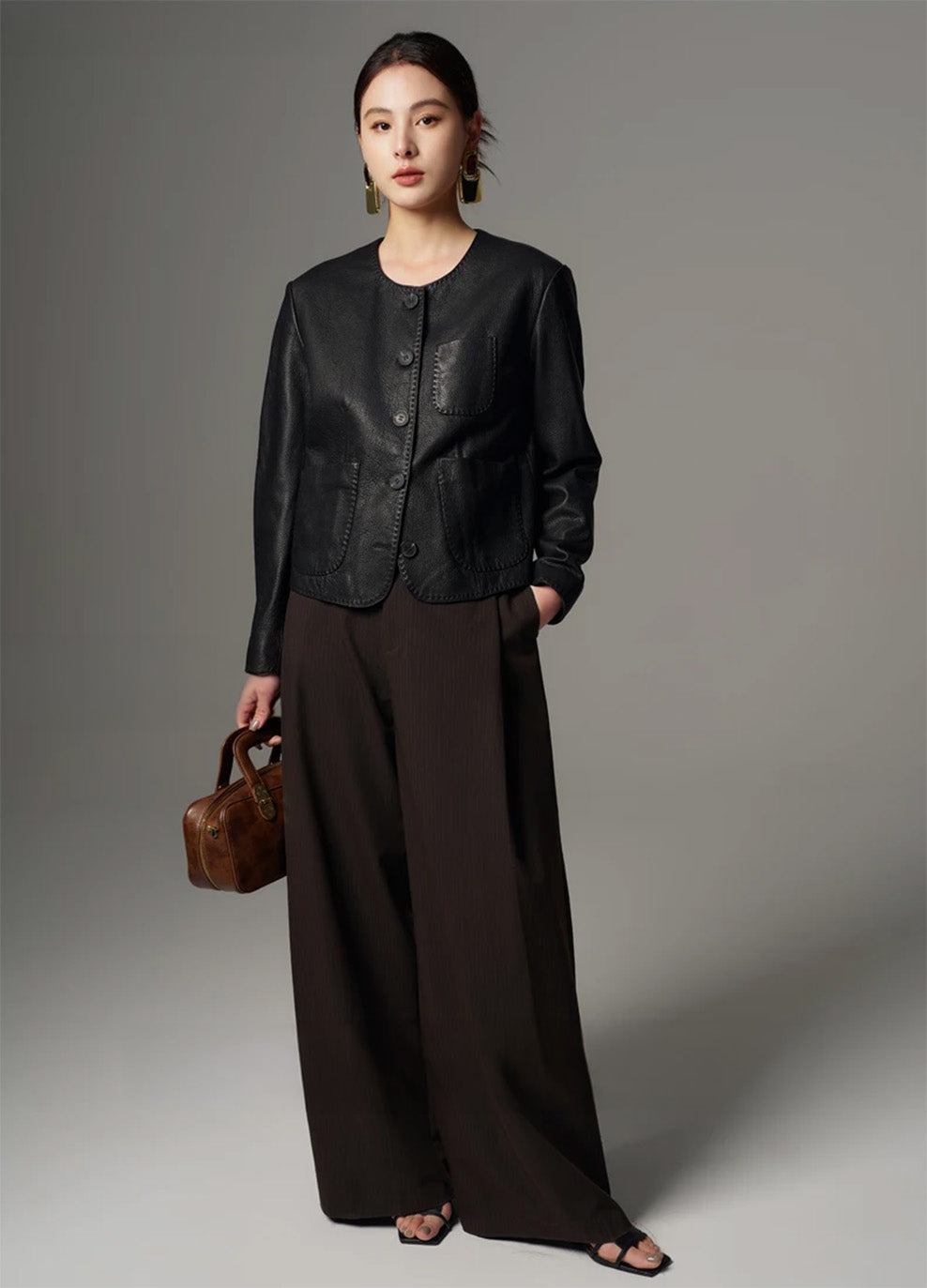 Full-length view of the model styled in the cropped pebble goatskin jacket and trousers — From Borcelleclothes.