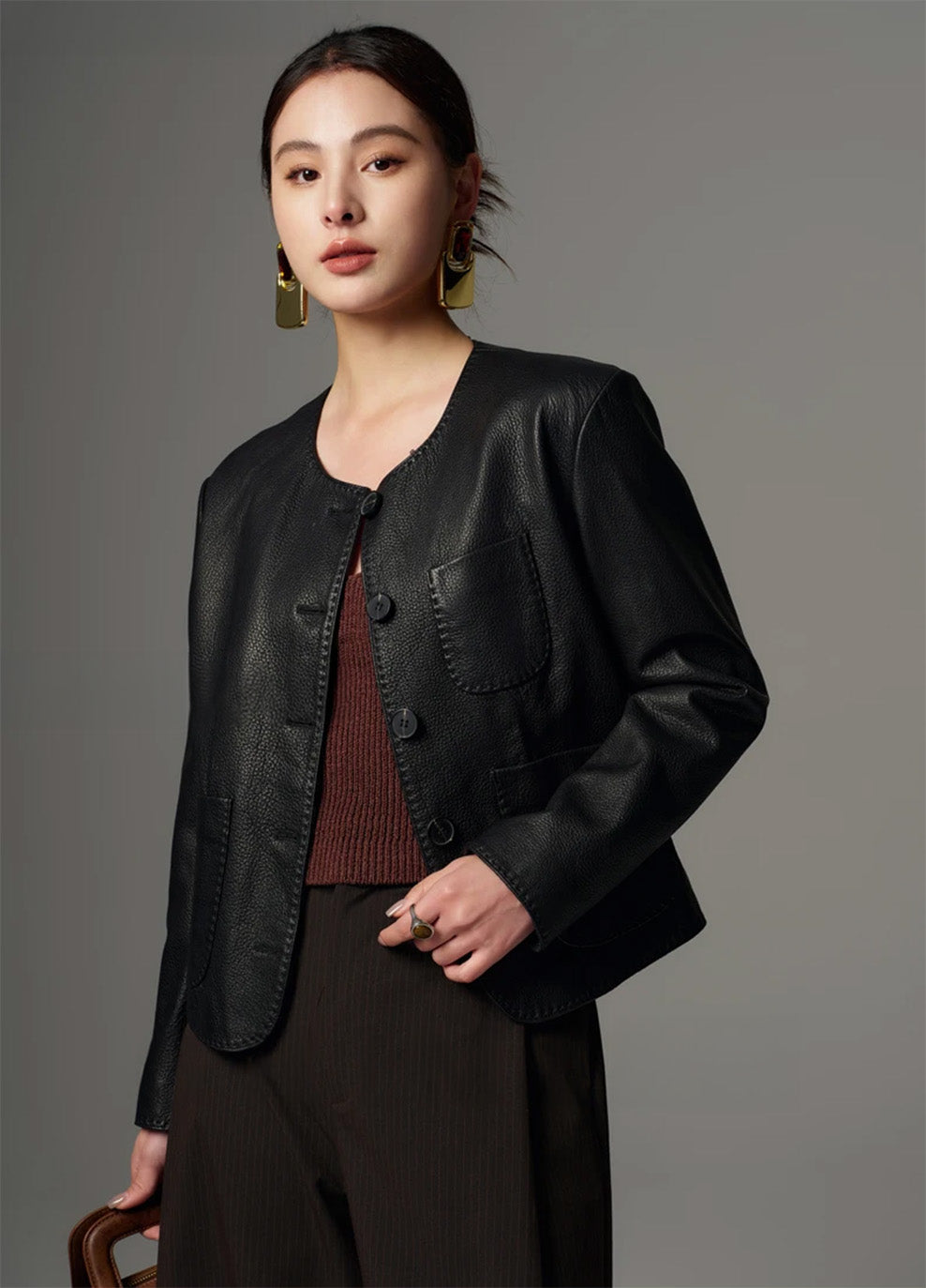 Model with bent arm showcasing the supple leather and structured sleeve of the unfastened jacket — From Borcelleclothes.