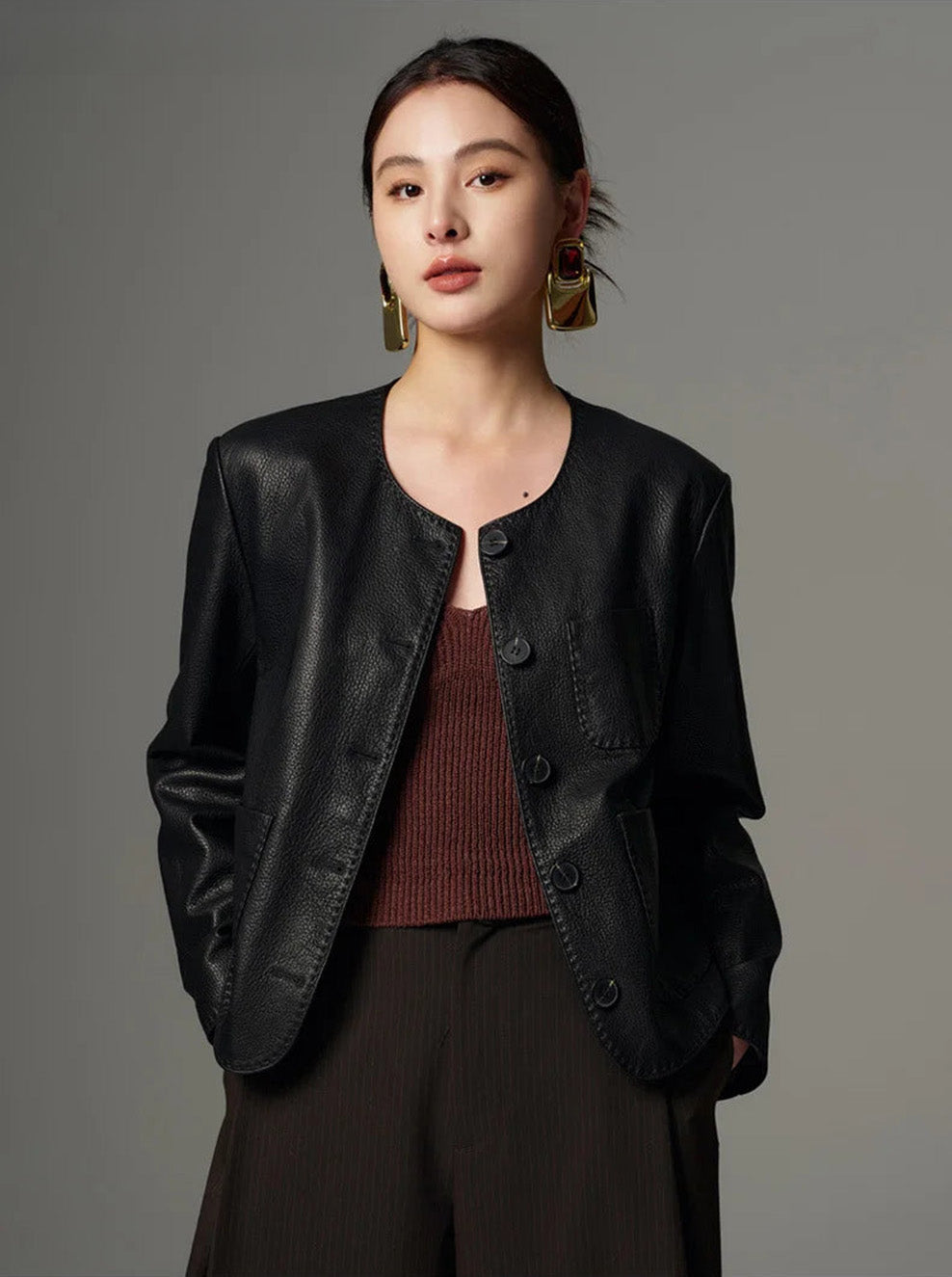 Model wearing the unfastened tailored goatskin jacket with hands tucked into trousers pockets — From Borcelleclothes.