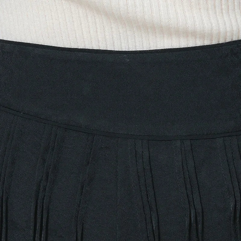 Detailed view of the middle front waist section featuring the asymmetrical yoke insert and vertical tucks — From Borcelleclothes.