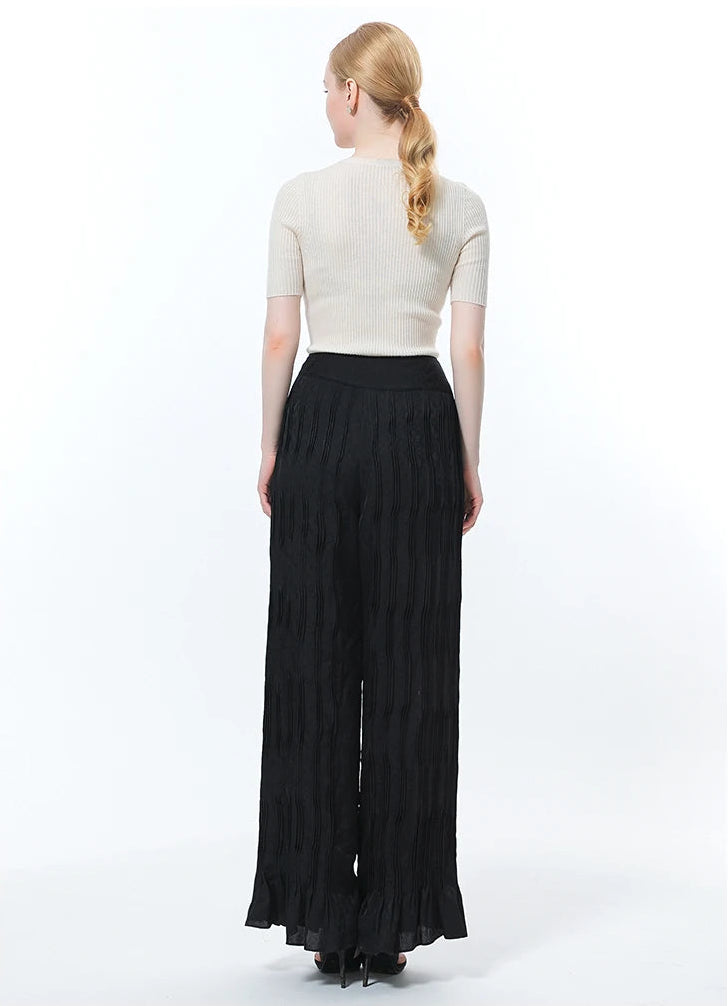 Full-length back view of wide-leg silk jacquard trousers in Hide-and-Seek on model — From Borcelleclothes.