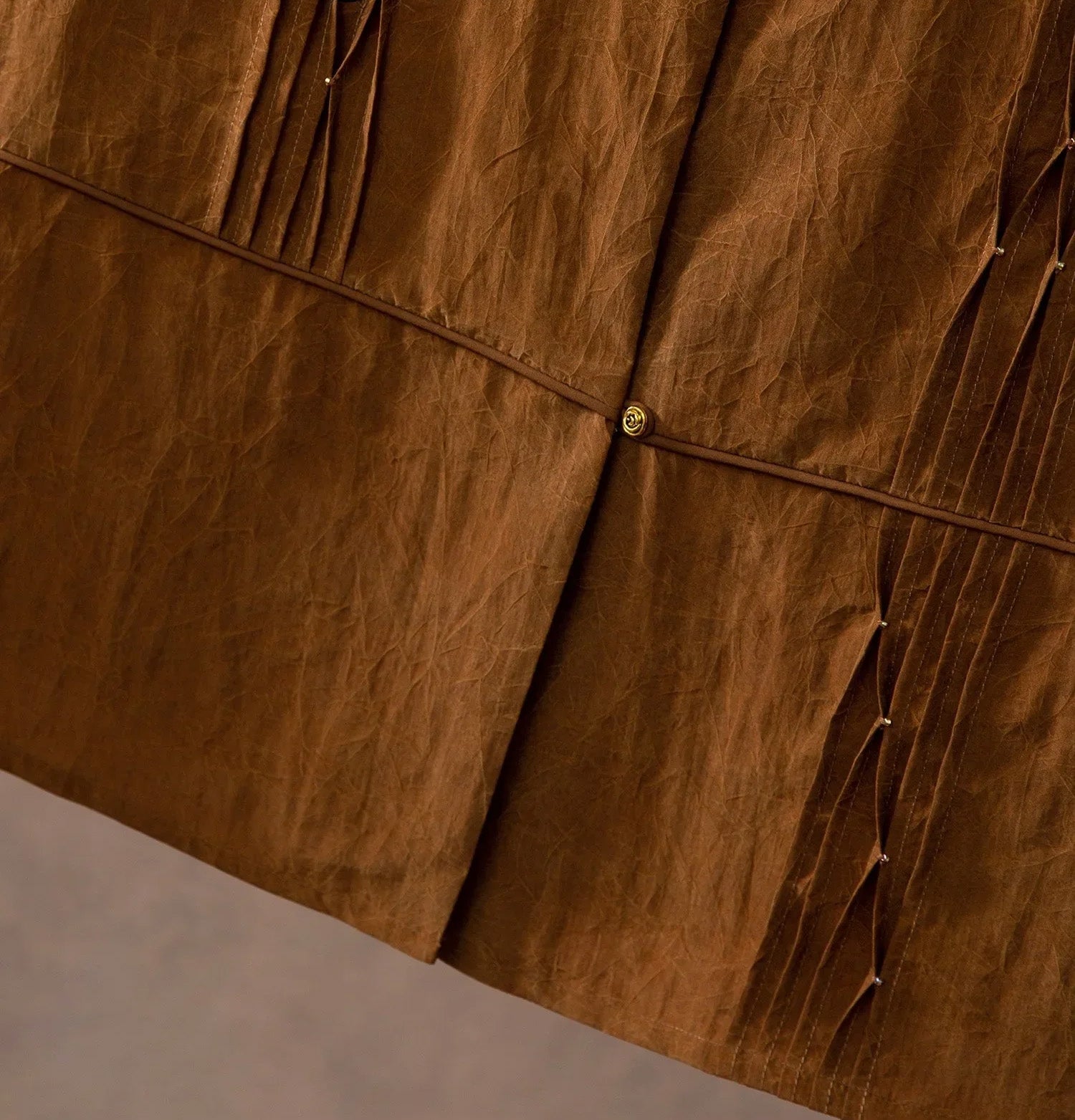 Bottom front hem detail of Tucked Xiangyunsha Mulberry Silk Blouse in Cinnamon Amulet — From Borcelleclothes.
