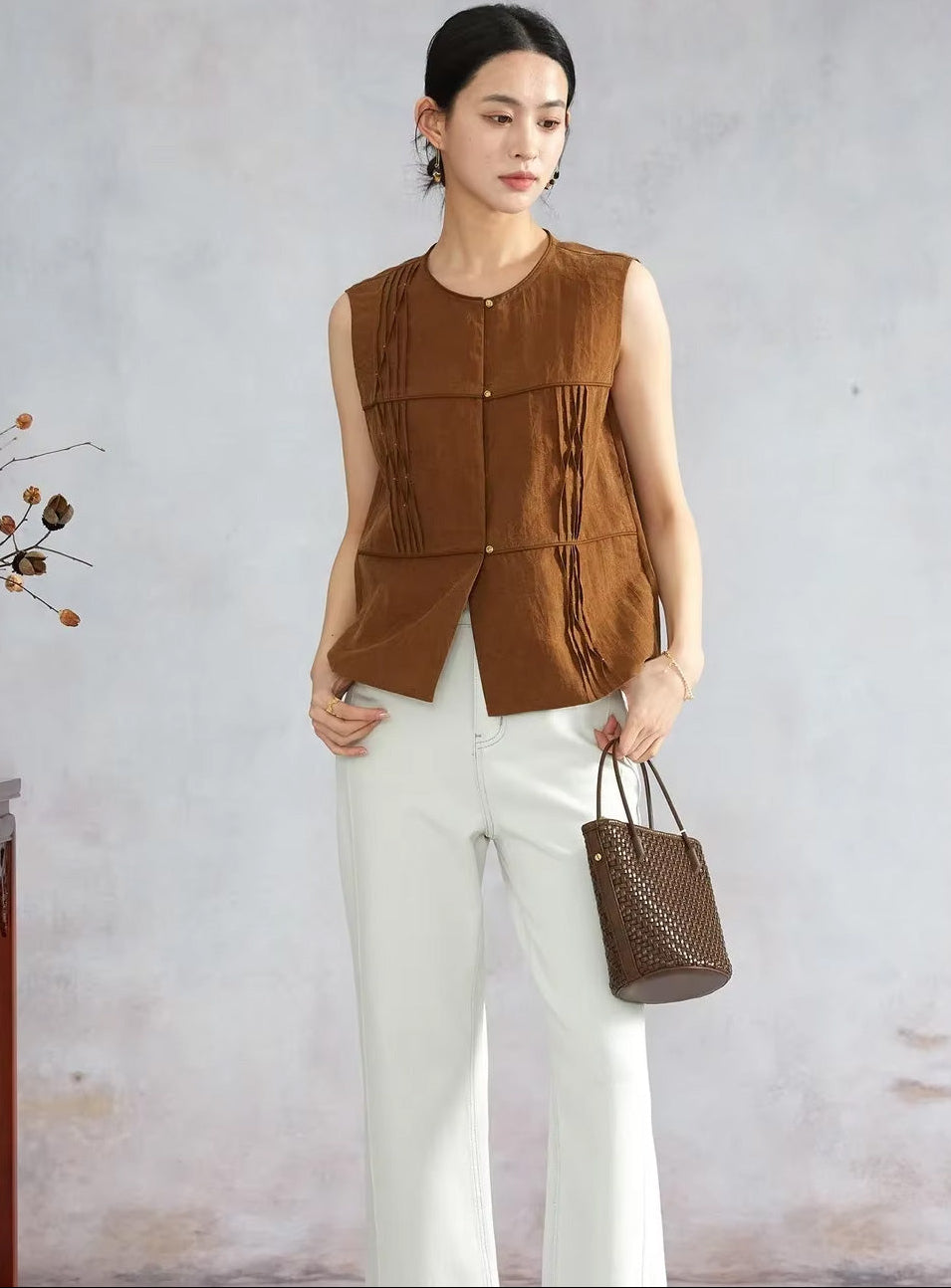 Women’s Tucked Xiangyunsha Mulberry Silk Blouse in Cinnamon Amulet worn by model holding a brown woven bag — From Borcelleclothes.