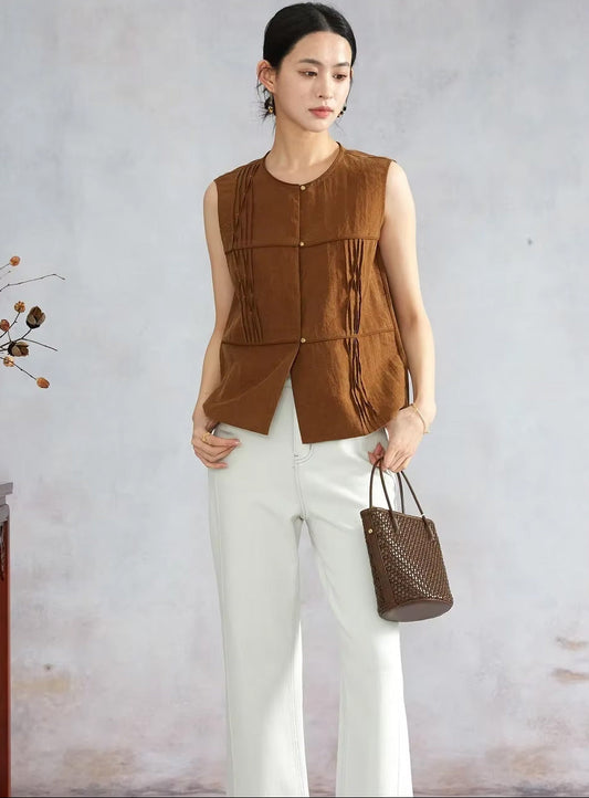 Women’s Tucked Xiangyunsha Mulberry Silk Blouse in Cinnamon Amulet worn by model holding a brown woven bag — From Borcelleclothes.