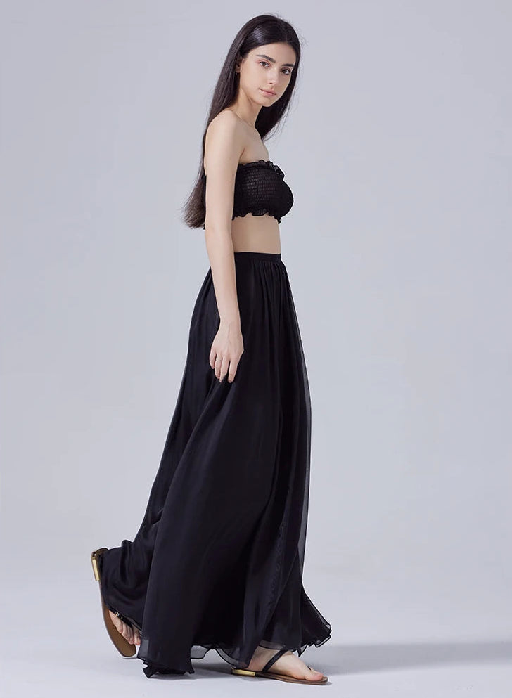 Side view of model walking, showcasing the fluid motion of pleated Mulberry silk chiffon skirt — From Borcelleclothes.
