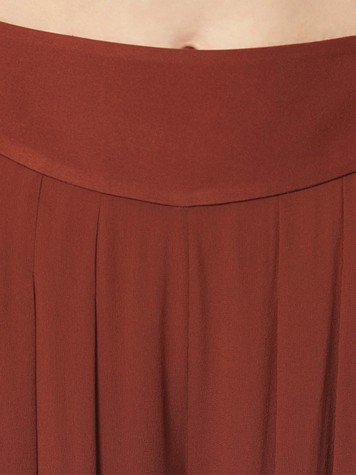 Detailed front view of the waist section and pleats on two-layer Mulberry silk georgette trousers in Contradictory Terracotta — From Borcelleclothes.