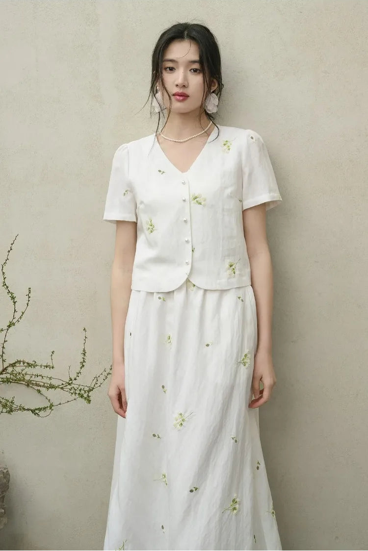 A woman standing straight in the full Utsugi Blossom viscose set, showcasing the harmony between the embroidered top and flared midi skirt — From Borcelleclothes.
