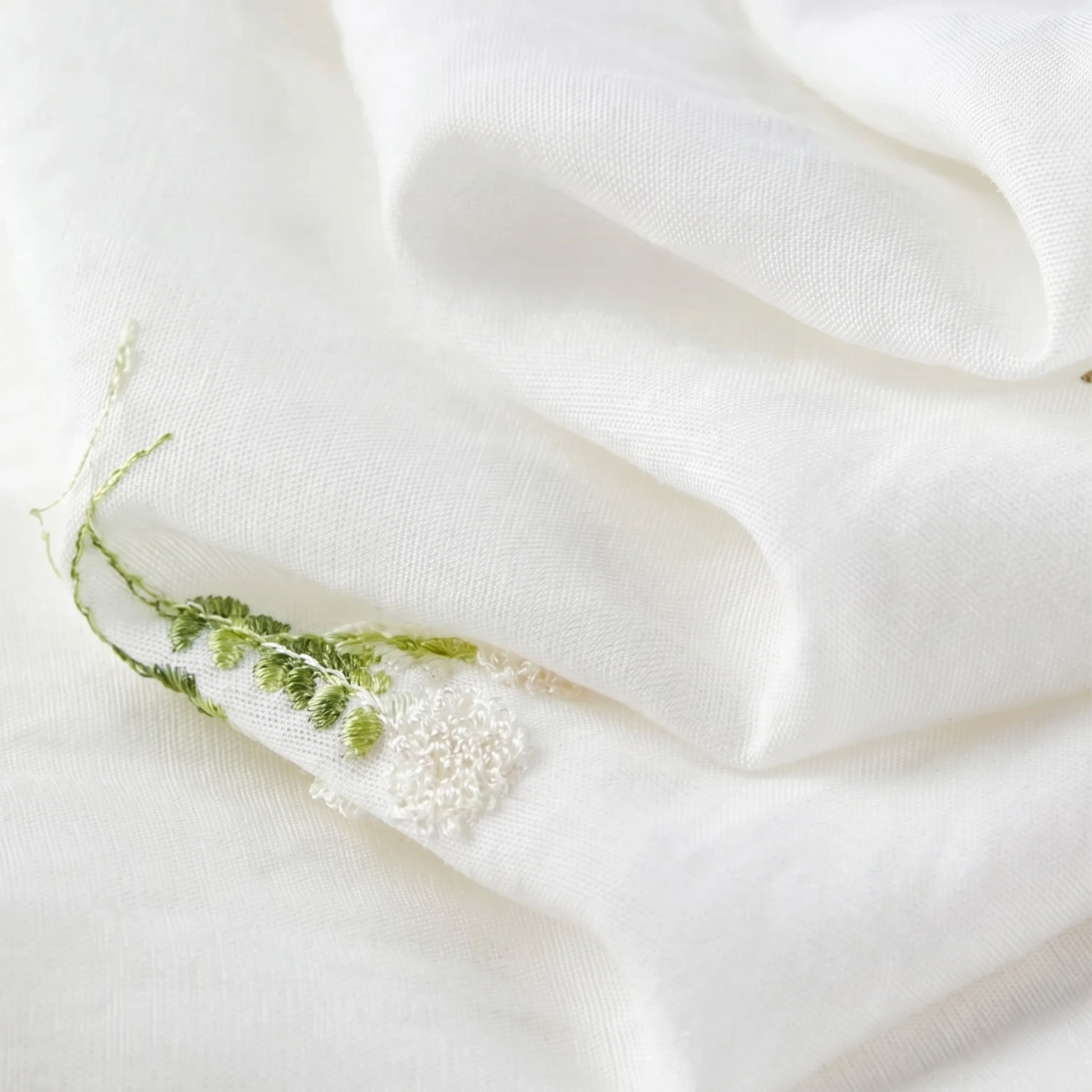 Close-up of the Bride’s Silence viscose-linen fabric, folded in soft waves to reveal the natural texture and ethereal quality of the Utsugi set — From Borcelleclothes.