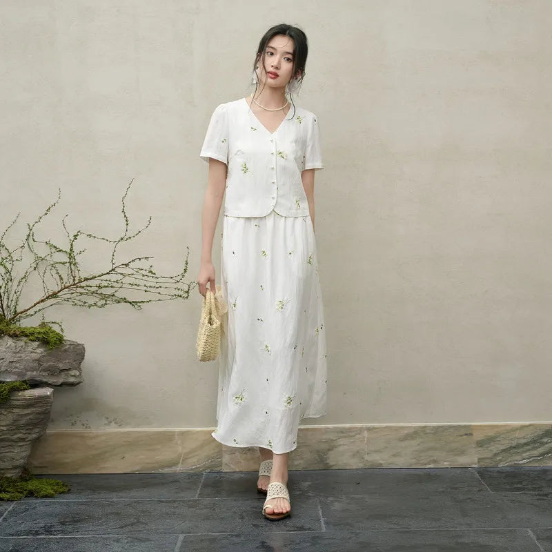 Women's Utsugi Blossom set in Bride’s Silence white. Cropped viscose-linen top with five pearl buttons and 3D floral embroidery, paired with a flared midi skirt. — From Borcelleclothes.