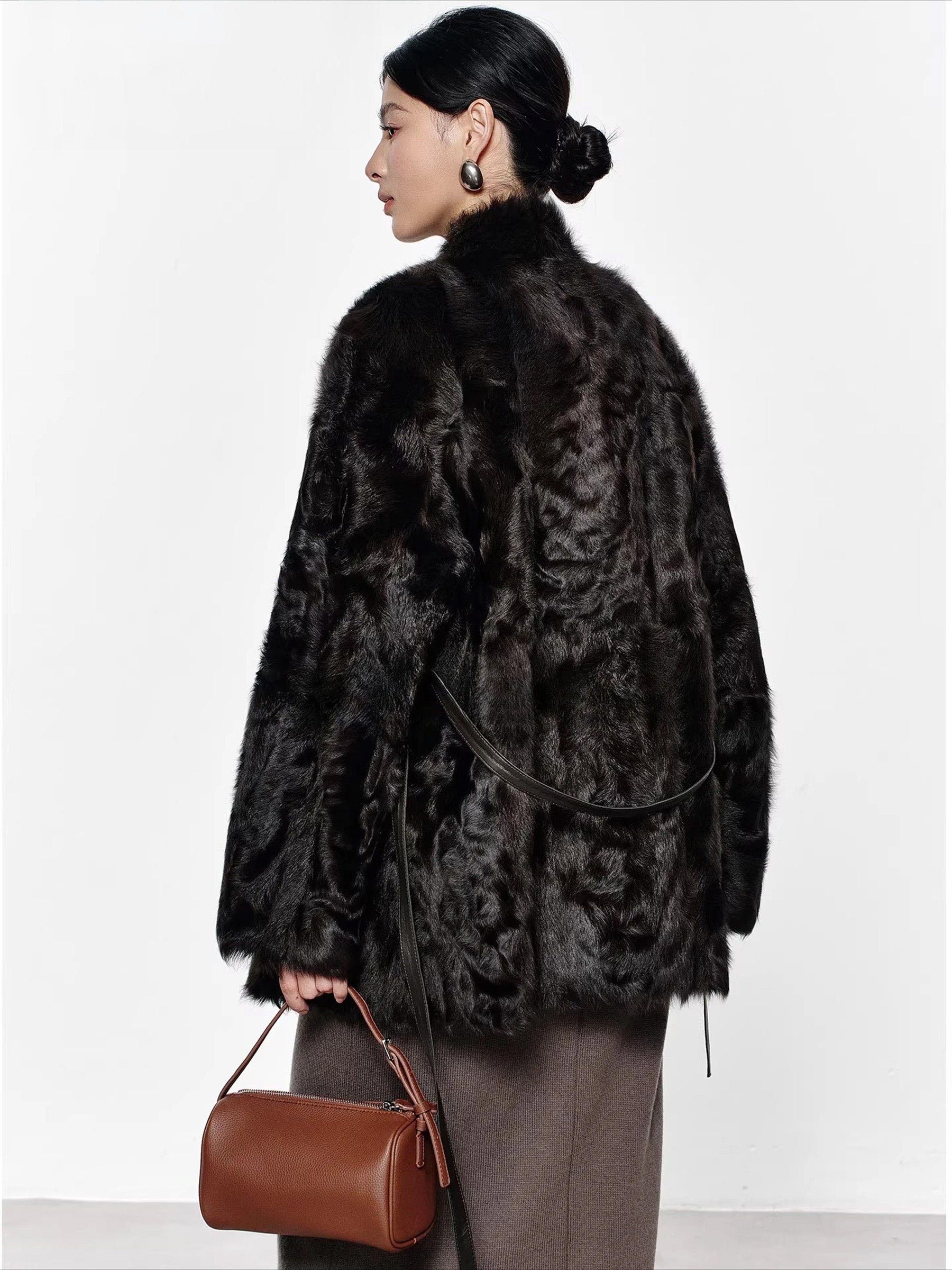 Back view of the Henna Glow V-neckline shearling coat worn by model, showing straight silhouette and clean back line — From Borcelleclothes.