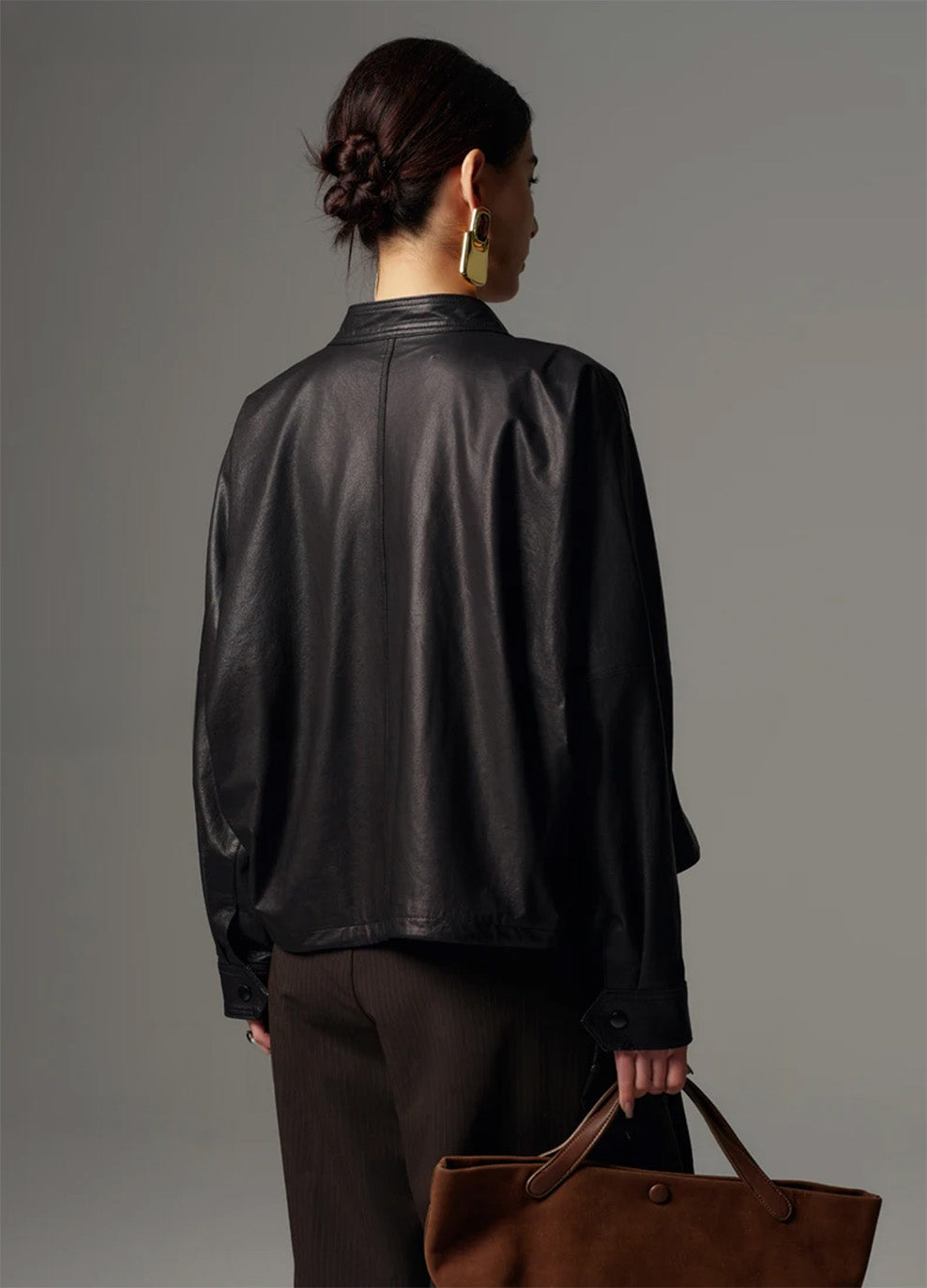 Back view of the relaxed cropped leather jacket, highlighting the clean silhouette and draped kimono sleeve construction — From Borcelleclothes.