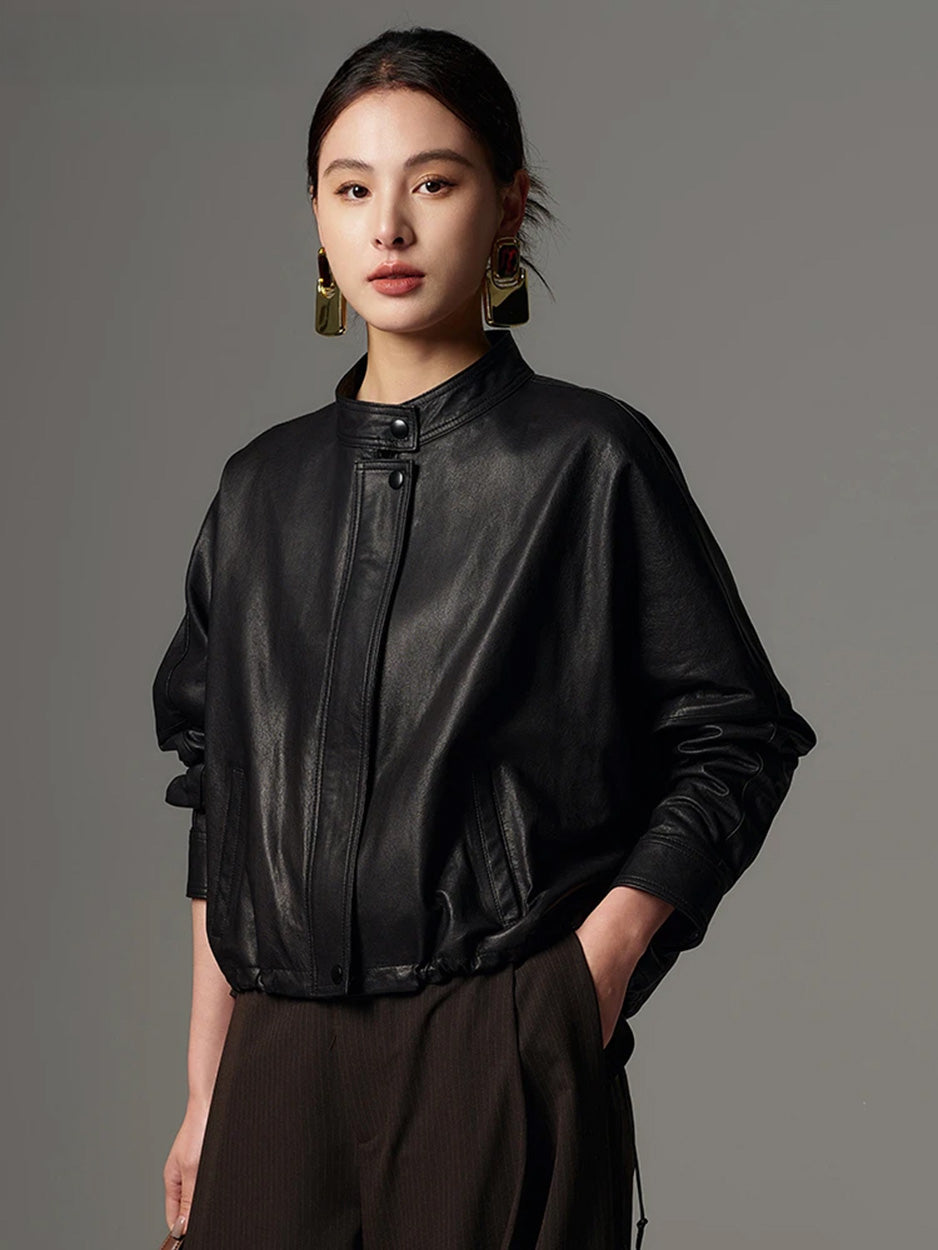 Full-length styling of the black sheepskin jacket with the model placing one hand in her tailored trouser pocket — From Borcelleclothes.