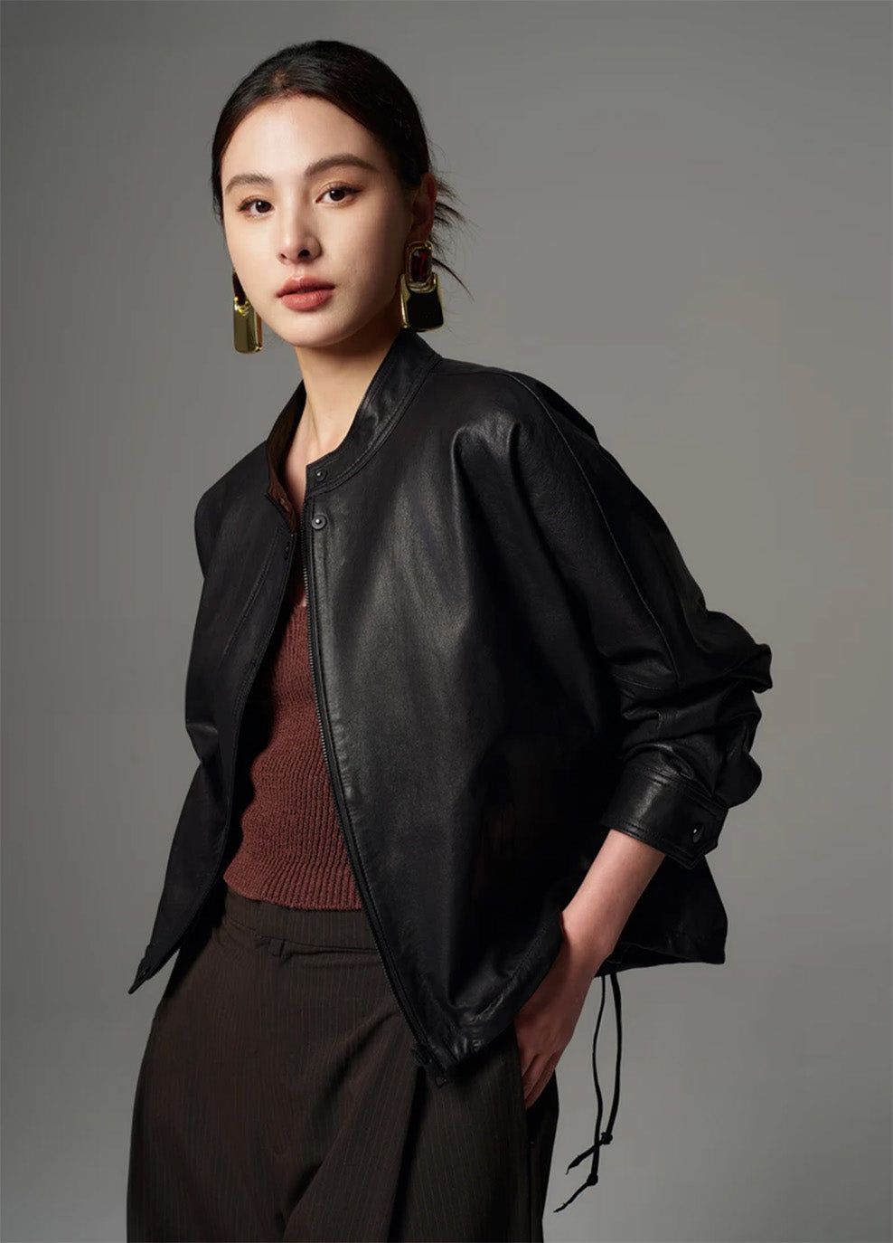 Model turned slightly to the side, showcasing the cropped profile and loose side drawstrings at the hem — From Borcelleclothes.