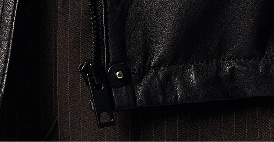 Macro detail of the metal zipper puller concealed beneath the front snapped placket of the leather jacket — From Borcelleclothes.