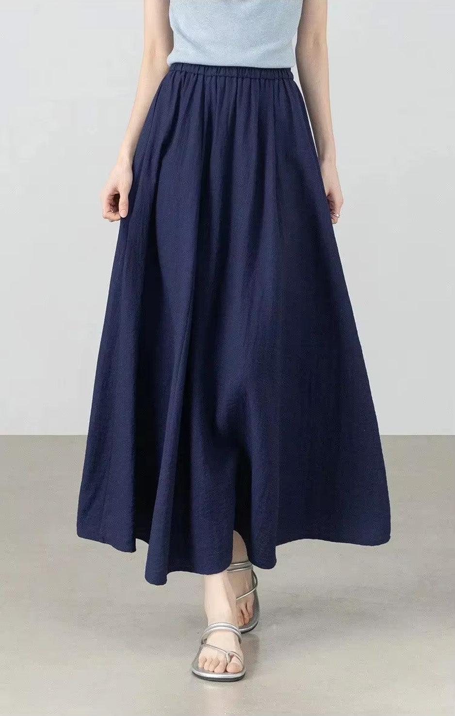 Front view of a model walking forward, showcasing the beautiful fluid movement of the Shurima Oasis gathered skirt — From Borcelleclothes.