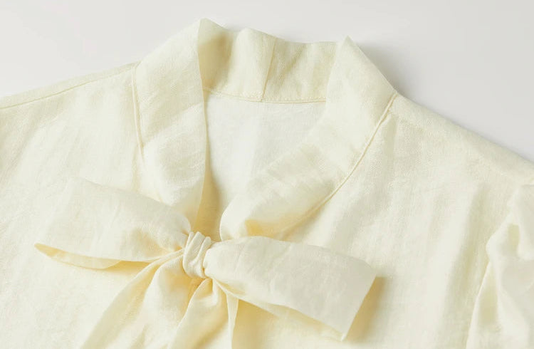 Macro view of the generous elderflower fizz ribbons tied into a lush, festive bow — From Borcelleclothes.