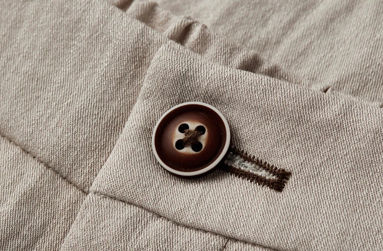 Close-up of the contrast button and adjustable waistband on the straight-cut trousers — From Borcelleclothes.