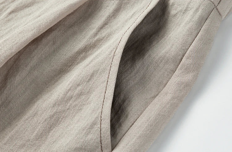 Focus on the side slash pocket and the slightly crinkled texture of the viscose blend trousers — From Borcelleclothes.