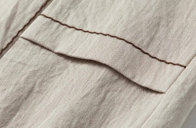 Close-up of the patch pocket on the vest, featuring matching chocolate wave-stitch embroidery — From Borcelleclothes.