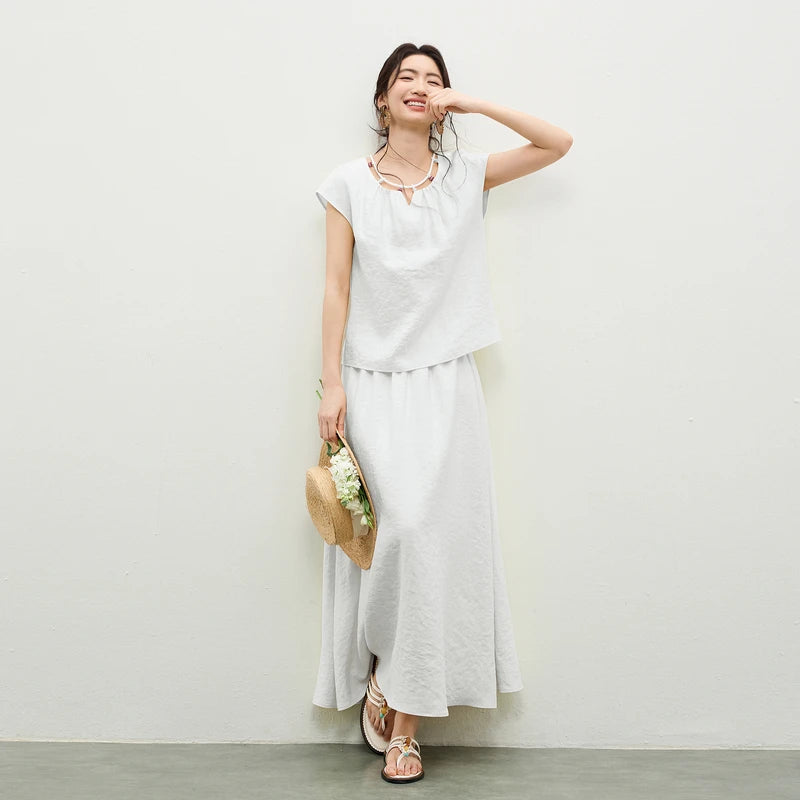 Two-piece natural viscose set in Beaded Spell color, featuring a crinkled texture top with a beaded drawstring neckline and a flared midi skirt. — From Borcelleclothes.