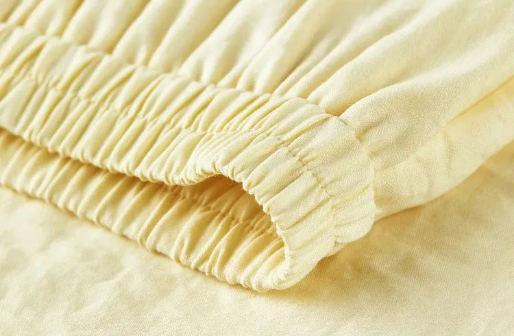 Close-up of the comfortable elasticated waistband on the flared midi skirt — From Borcelleclothes.