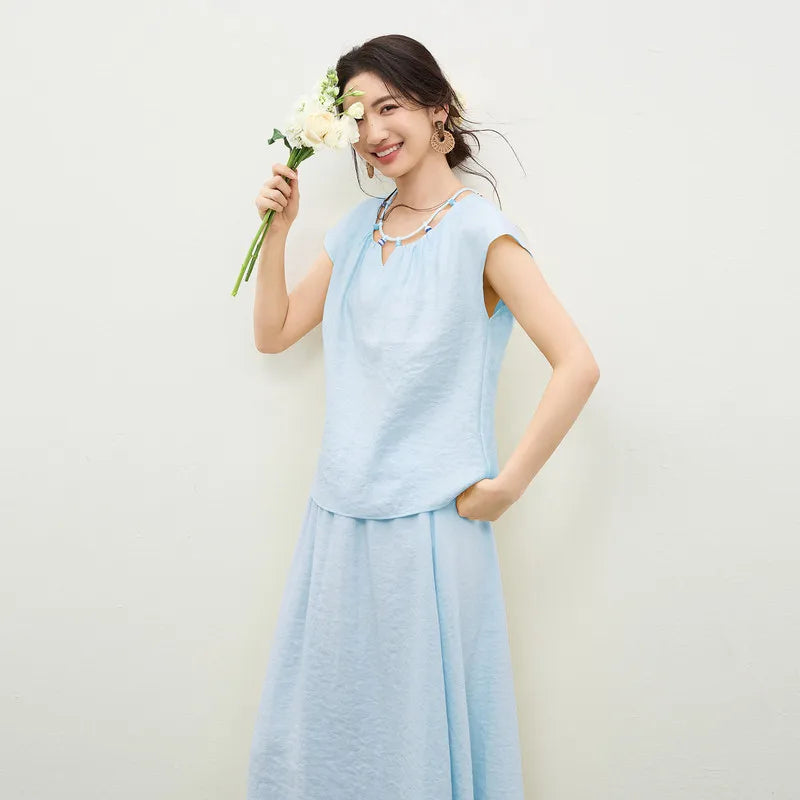 Two-piece natural viscose set in Sky Necklace color, featuring a crinkled texture top with a beaded drawstring neckline and a flared midi skirt. — From Borcelleclothes.