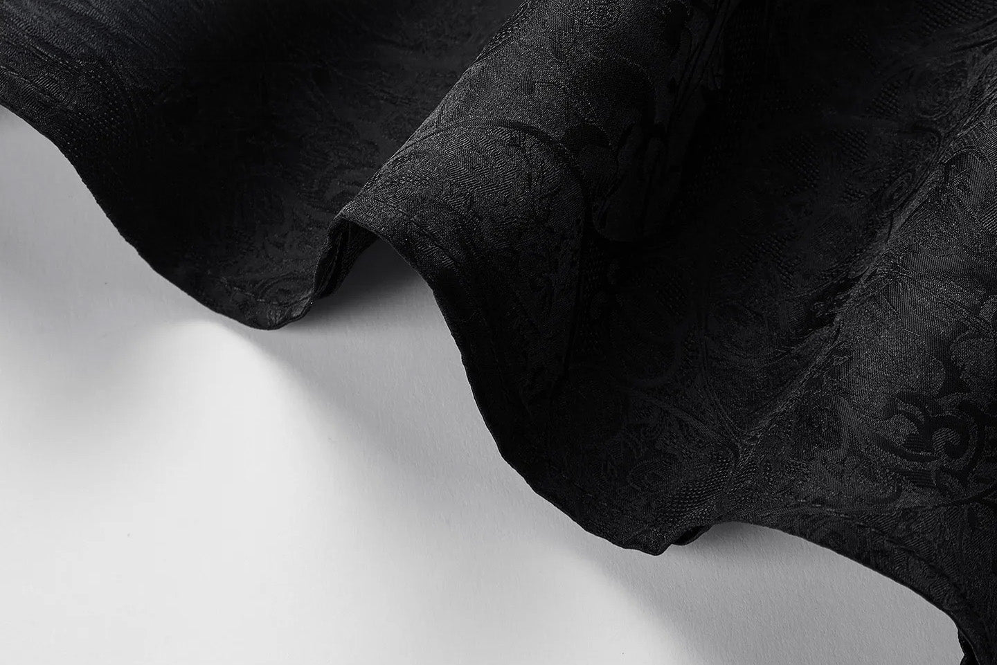 Detailed view of the bottom hem with side slit tailoring on a Freezing Twilight viscose-silk jacquard top. — From Borcelleclothes.