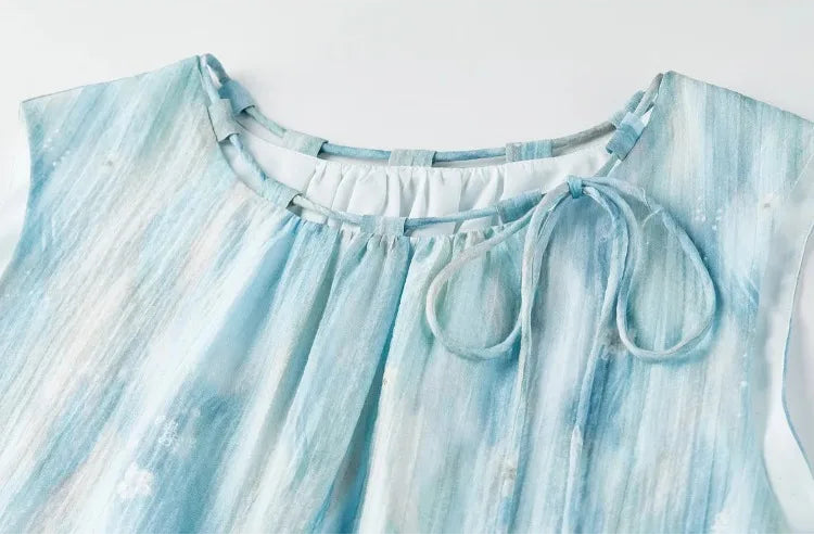 Close-up of the unique adjustable neckline with fabric loops and threaded tie on the lyocell top — From Borcelleclothes.